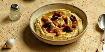 Hummus adalah pasta kacang kacangan yang lezat yang terbuat dari kacang kacangan, biasanya kacang kacang tanah, dicampur dengan lemon, bawang putih, dan minyak zaitun. menu sarapan pagi timur tengah atau sarapan pagi orang arab