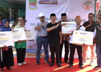 Pj Bupati Bekasi Dani Ramdan memberikan penghargaan kepada 5 desa yang berhasil memenangkan Lomba Program Kampung Iklim (Proklim) di RW 37 Kelurahan Wanasari Kecamatan Cibitung, pada Sabtu (10/08/2024).(FOTO: Humas Pemkab Bekasi)