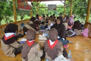 Guru dan siswa melaksanakan kegiatan belajar mengajar dengan materi mewarnai buah mangga yang dikerjakan di dalam Saung Agrimania. (Dok. Satujabar.com)