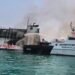Kapal Negara (KN) Trisula P.111 melakukan proses pendidingan kebakaran KMP Batumandi di alur masuk Pelabuhan Penyeberangan Merak, Banten.(Foto: Ditjen Hubla Kemenhub)